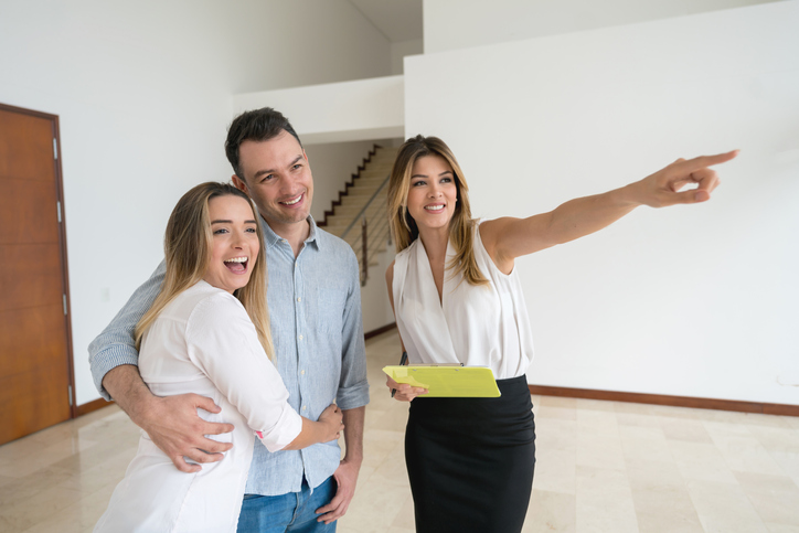 Real estate agent showing a house to a couple
